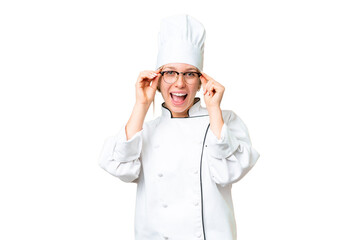 Young chef woman over isolated chroma key background with glasses and surprised