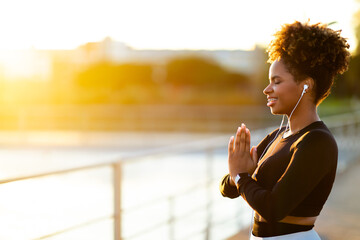 Yoga Outdoors. Portrait Of Smiling Young Black Woman Meditating Outside