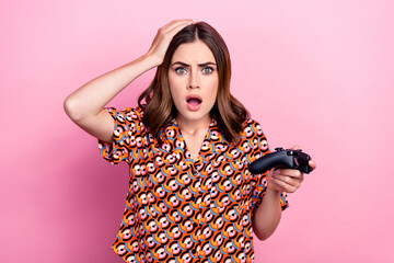 Photo portrait of attractive young woman arm touch head playstation terrified wear trendy print clothes isolated on pink color background