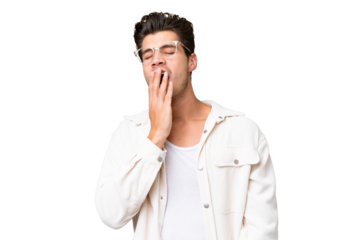 Young handsome caucasian man over isolated background yawning and covering wide open mouth with hand
