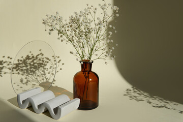still life with flowers. white flowers in an amber vase on a light background with a beautiful shadow. composition of beautiful flower background.