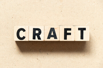 Alphabet letter block in word craft on wood background