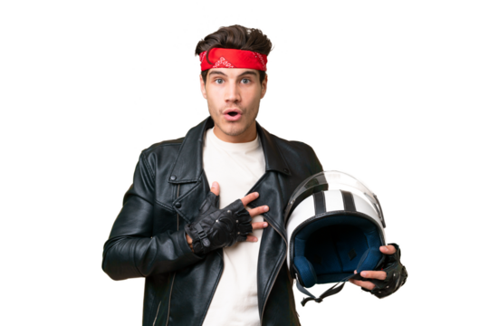 Young caucasian man with a motorcycle helmet over isolated background surprised and shocked while looking right