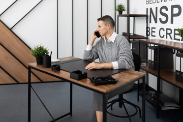adult woman business executive talking on mobile phone at desk in office