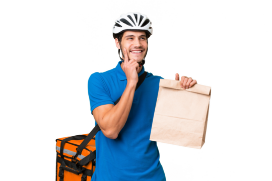 Young caucasian man taking a bag of takeaway food over isolated background thinking an idea while looking up