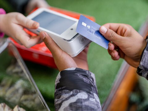 Young man paying by card