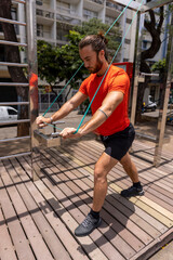 Man in sports clothing exercising in city