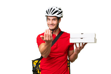 Pizza delivery man with work uniform picking up pizza boxes over isolated background inviting to...