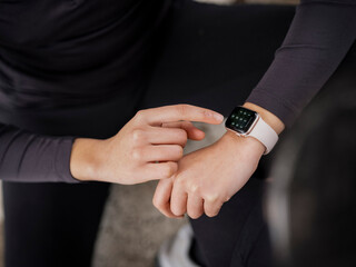 Close-up of athlete woman checking smart watch