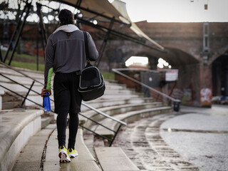 Rear view of athletic man with gym bag walking outdoors © Cultura Creative