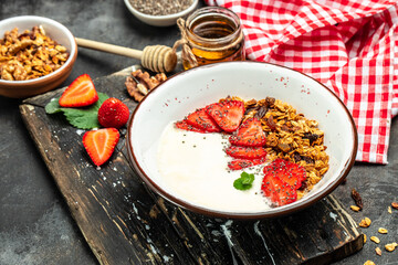 Fresh breakfast with greek yogurt nuts oatmeal granola with berries in a bowl. Delicious breakfast or snack, top view