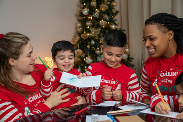 Moms with kids preparing Christmas cards at home