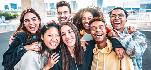 Happy group of young people smiling at camera outdoors - Smiling friends having fun hanging out on city street - University students standing together in college campus - Friendship and youth concept