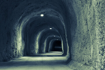 Dimly lit Mountain Tunnel. Art long tunnel for publication, design, poster, calendar, post, screensaver, wallpaper, postcard, cover, banner, website. Toned high quality photo