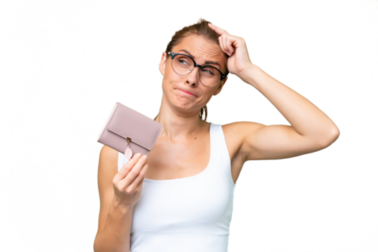 Young caucasian woman holding a wallet over isolated background having doubts and with confuse face expression