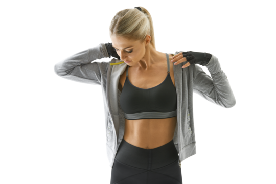 Sportswoman in sportswear, gloves, black top and leggings adjusts her collar after training