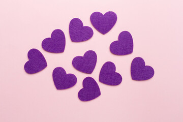 Felt hearts on color background, top view