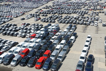 Barcelona, Spain - 08 06 2022: Brand new cars of different colors from known producers are parking in terminal of Spanish port and are ready to be loaded on the ship and  transported to customers.