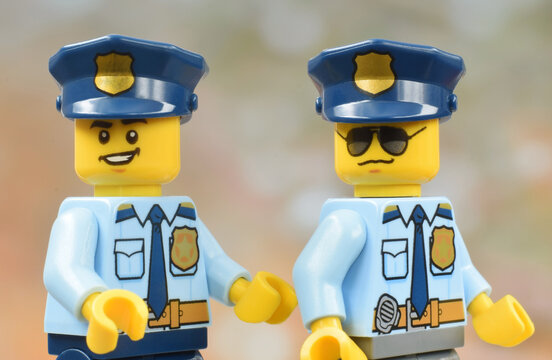 Lego minifigures of police officers male in uniform. Editorial illustrative image of job in justice. Studio shot.