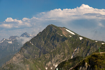 Russia, Sochi, Krasnaya Polyana. Summer landscapes of the Caucasus mountains in Rosa Khutor. View of the peaks of the mountains