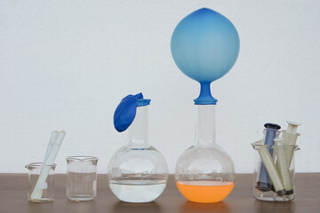 Blue balloons on top of test tubes. Concept, easy and fun Science experiment about the reaction of...