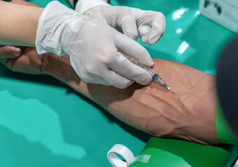 Close up needle draw blood on arm's patient.