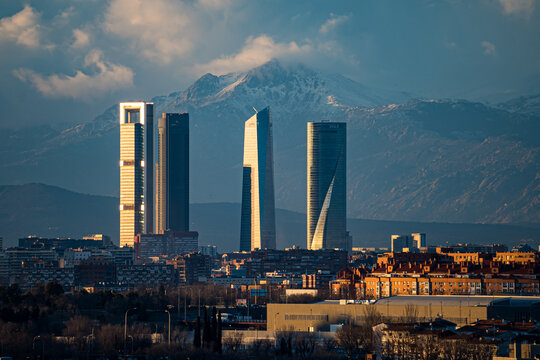 City of Madrid with the towers of Castellana street and the Navacerrada mountain with snow.