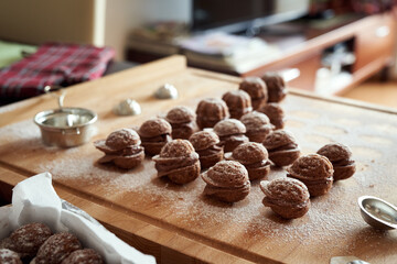 Preparation of Christmas cookies in the form of nuts - dusting with sugar