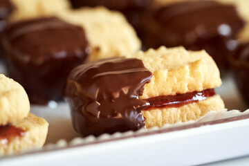 Christmas cookie filled with marmalade and dipped in chocolate