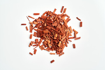 Red sandalwood chips on white background, top view