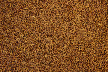 The texture of dry buckwheat. Background image of buckwheat porridge.