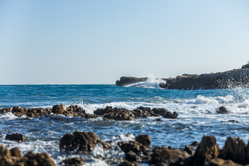 Fototapeta na wymiar Waves crashing on rocks on Cap d'Antibes, France