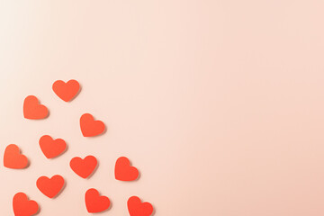 Happy Valentine's day concept. Symbol of love paper art with copy space for text, handmade red paper hearts shape cutting pastel pink background, Mother's Day