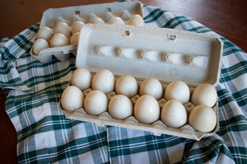 Two dozen duck eggs in carton