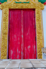 Red vintage door of old buddhism temple .