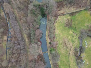 Aerial view looking down onto a lake surrounded by trees and green fields. Taken in Bury Lancashire. 
