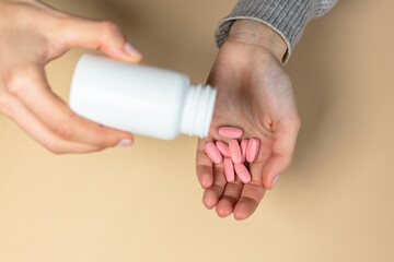pink pills on hands