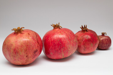 Row of red fresh pomegranates