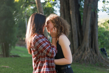 Fototapeta premium Beautiful women LGBT Lesbian Couple intimate moments. Young couple multiracial female friends. multi-ethnic female couple in love hug each other