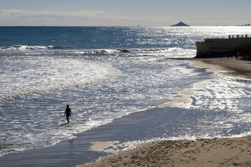 Spectacular beach scene at sunset with young girl