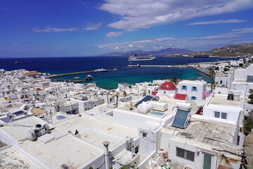 Mykonos cityscape with whitewashed houses and cruise liner in Mediterranean Sea, Greece