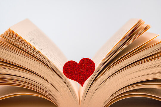 Red heart on the open book