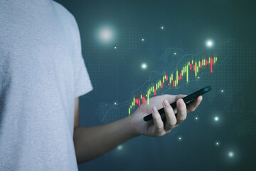 Businessman or trader use smartphone for Investing in stock market trading and digital assets with virtual hologram stocks, planning and strategy, progress or success, financial analysis, exchange