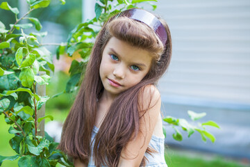 young beautiful preschool girl in a summer park