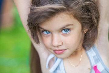 young beautiful preschool girl in a summer park