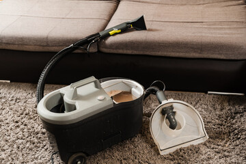 Dry cleaning extractor machine and tank of dirty water after dry cleaning of couch. Professional...