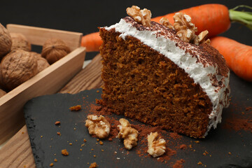 Carrot cake decorated with meringue, chocolate and walnuts along with some raw carrots and walnuts