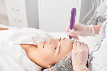 Cosmetologist makes mesotherapy injection for rejuvenation woman face, anti aging non surgical...