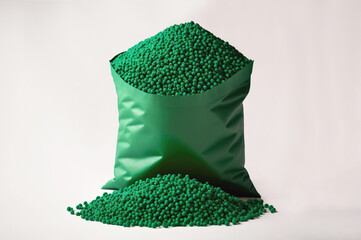 Bag with green biodegradable plastic granules. Raw materials of plastic Isolated on white. Generative AI