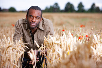 Rural Fashion, Ready for Harvest. A young farmer tending to his wheat crop in a rural English...